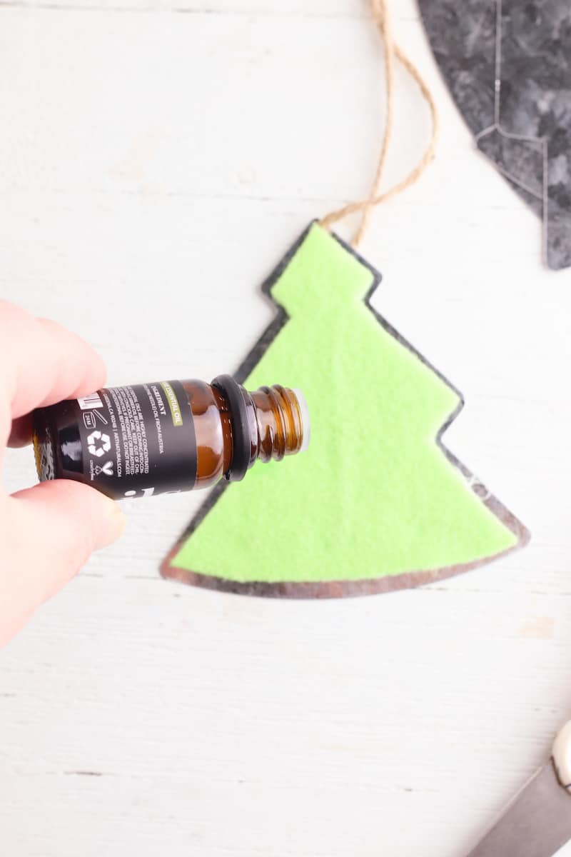 essential oil bottle held over felt tree pattern