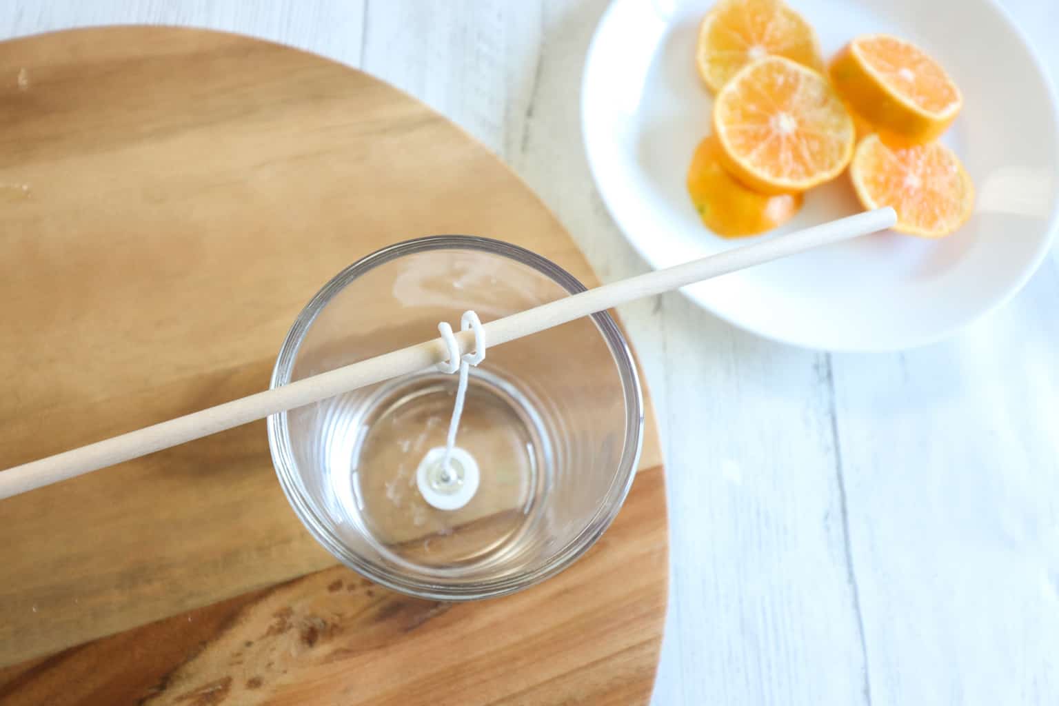 tying candle wick for a hand poured candle around a wooden dowel