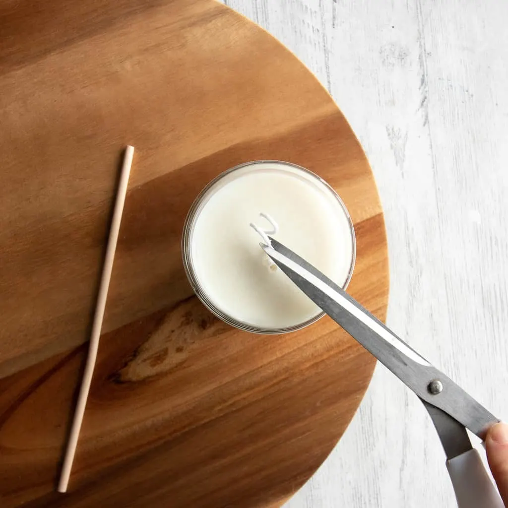 scissors trimming a candle wick