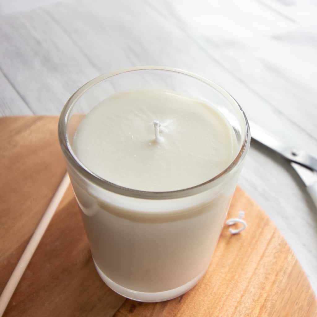 handmade candle with white wax in glass jar