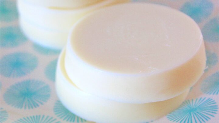 DIY lotion bars made from shea butter and beeswax stacked on plate