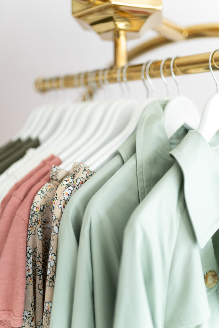 shirts on hangers hanging on clothing rack