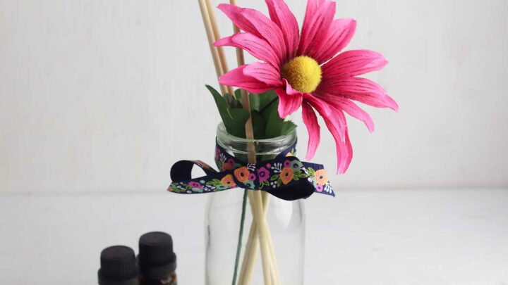 fake pink flower in handmade reed diffuser