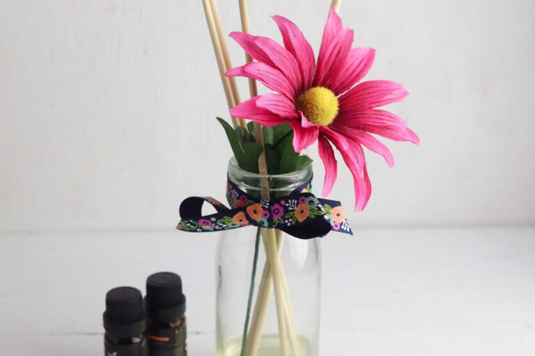 fake pink flower in handmade reed diffuser