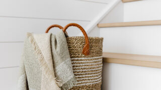 wool blanket in a basket on the stairs