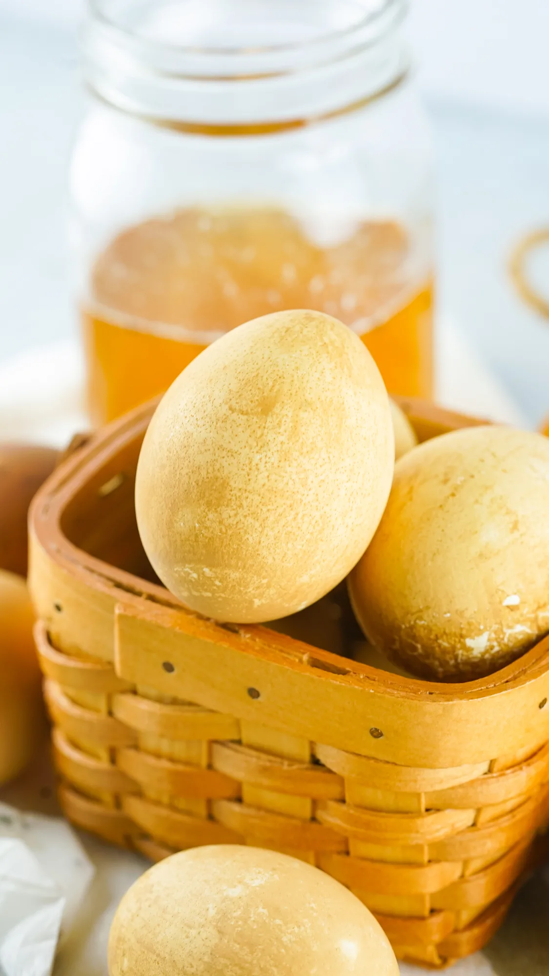 tea-dyed eggs in basket with jar of black tea in background