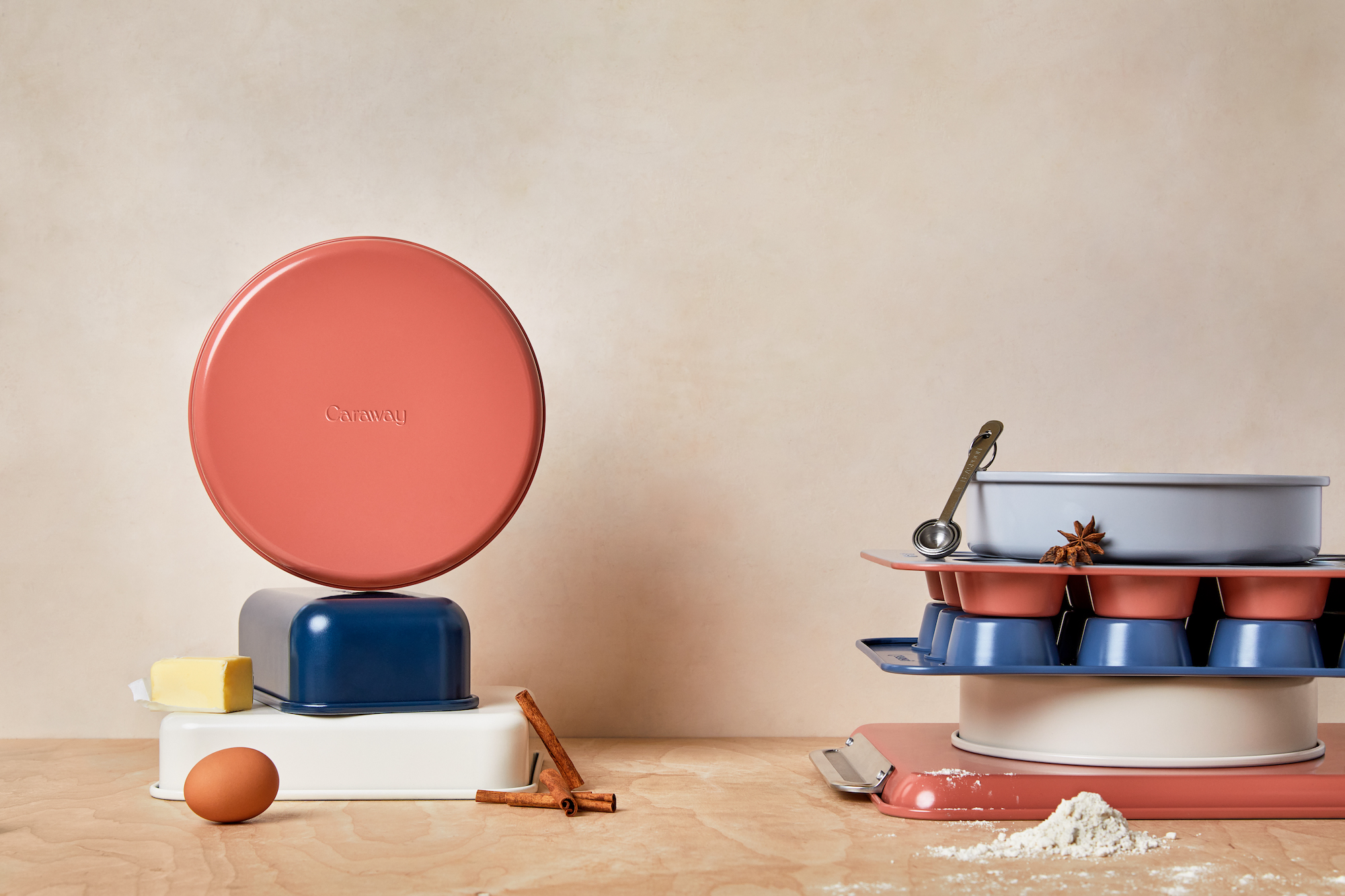 variety of pots and pans in different colors on kitchen countertop