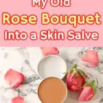 small aluminum tin filled with pink colored rose salve on marble background with fresh rose laying around it in a circle