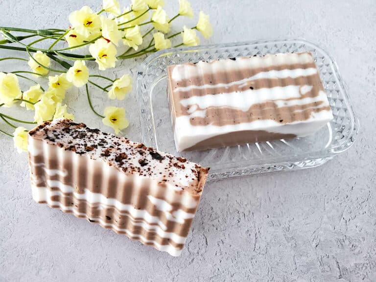 Chocolate Vanilla Soap with yellow flowers on a grey background