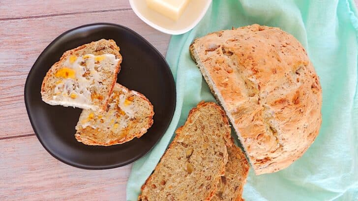 Copycat Dave's Killer Bread Recipe bread loaf with slices on black plate