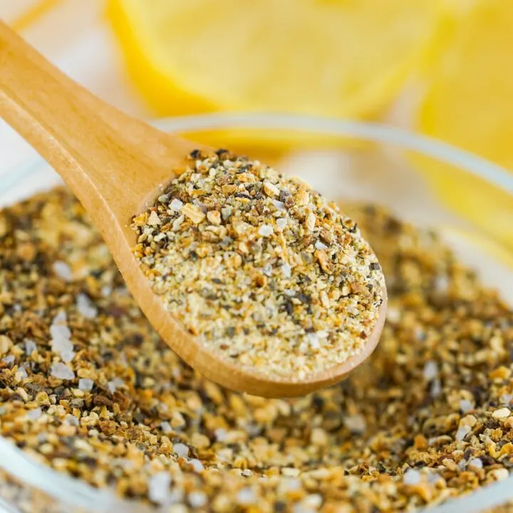 A glass bowl filled with homemade lemon pepper seasoning.
