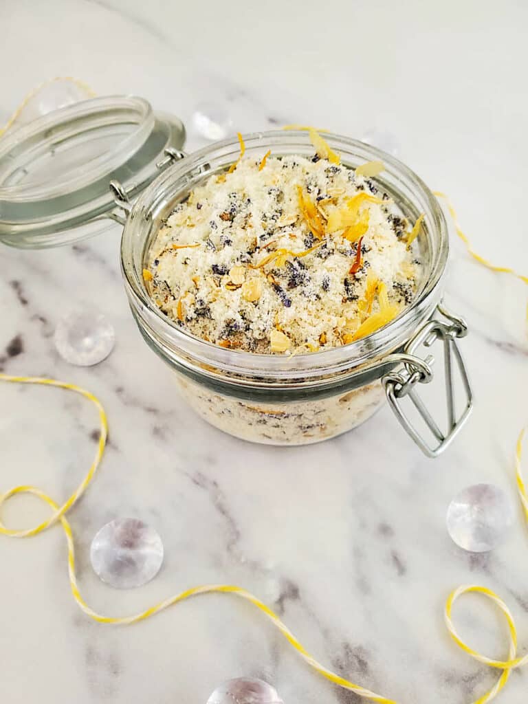 A glass jar filled with a mixture for a DIY oatmeal milk bath.