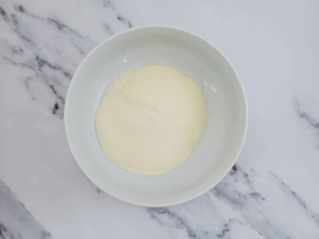 White powder in a bowl on a marble table.