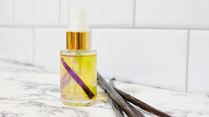 A bottle of DIY Vanilla Perfumes on a marble counter.