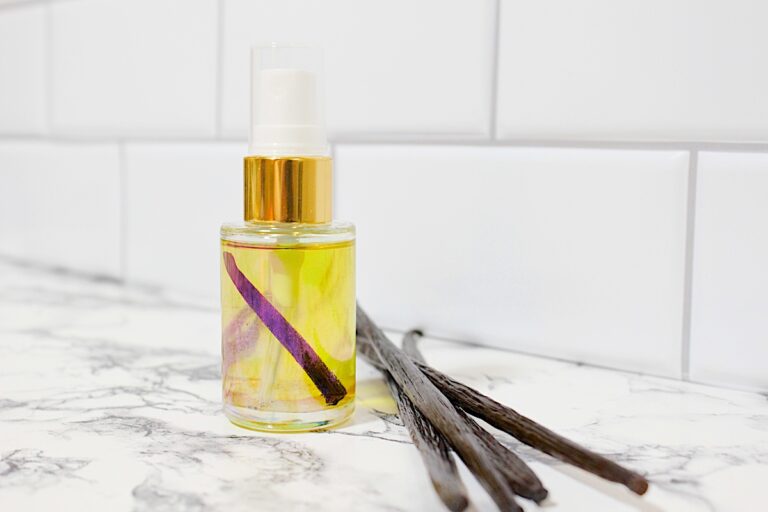 A bottle of DIY Vanilla Perfumes on a marble counter.