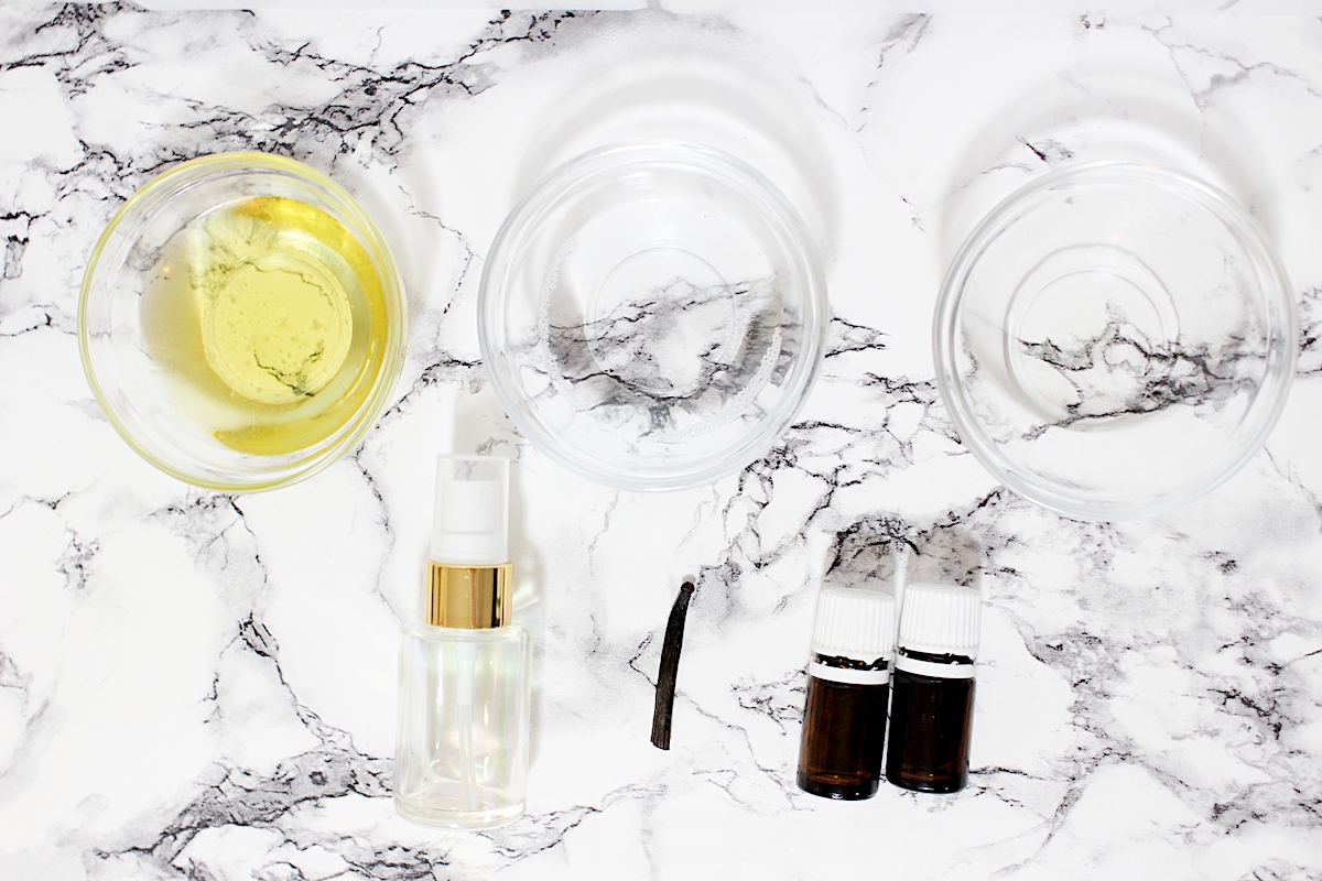 DIY Vanilla Perfume supplies on a white marble table top.