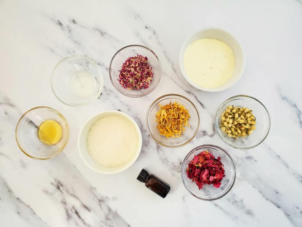 Ingredients for a homemade milk and honey floral bath soak.