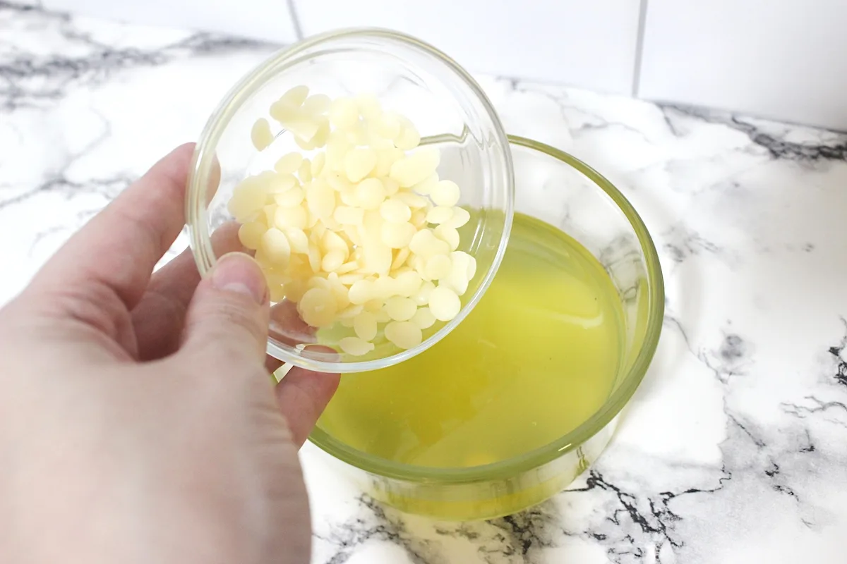 Rosemary Salve Step 1 pouring beeswax in a bowl and essential oils in a glass dish.