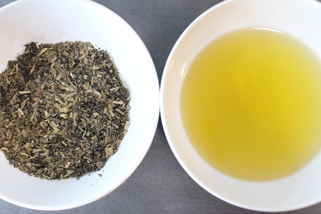 Comfrey Salve Ingredients in white bowls on a grey background