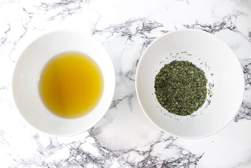 Plantain Salve Ingredients in two bowls on a marble surface