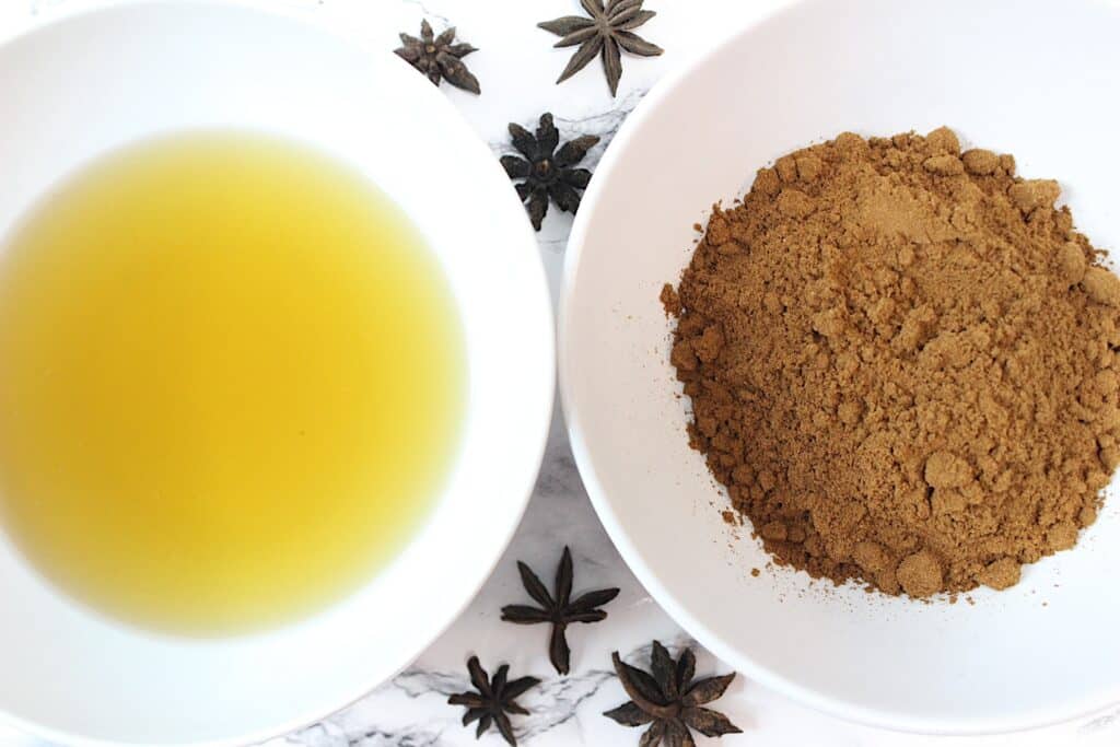 Star Anise Salve Ingredients in white bowls on a white marble surface