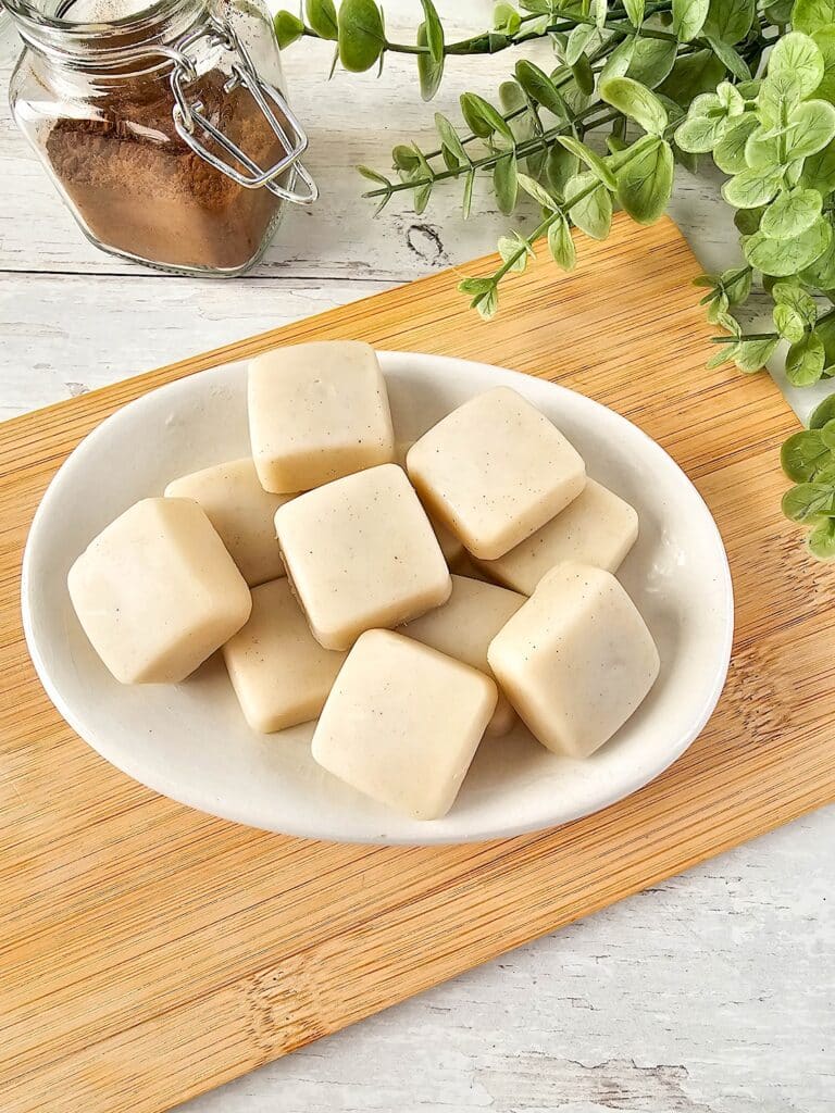Vanilla Homemade Lotion Bar - A white plate with some squares of soap on it.