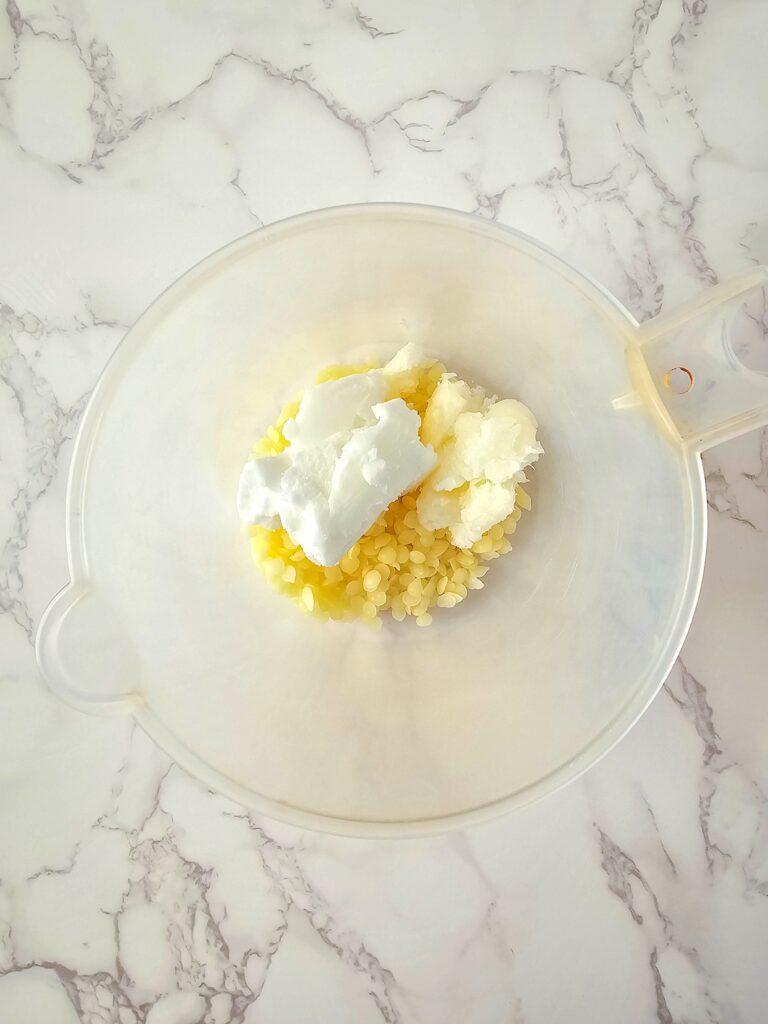 Vanilla Homemade Lotion Bar Step 2 - A bowl filled with whipped cream and a spoon.