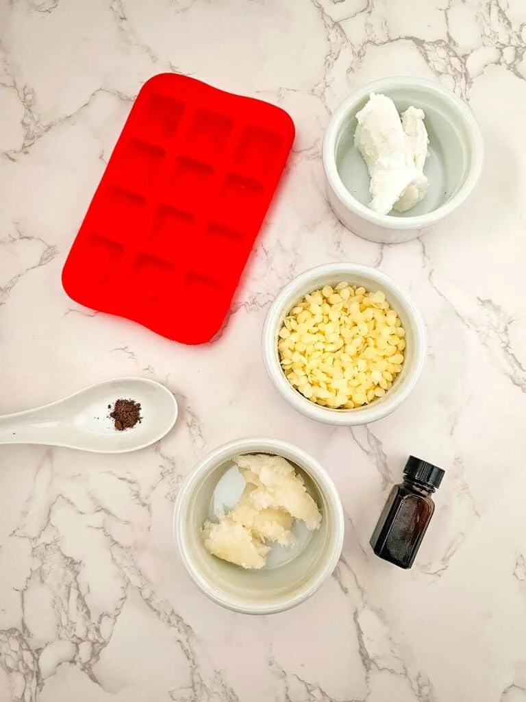 Vanilla Homemade Lotion Bar - A set of bowls with ingredients and a spoon on a marble countertop.