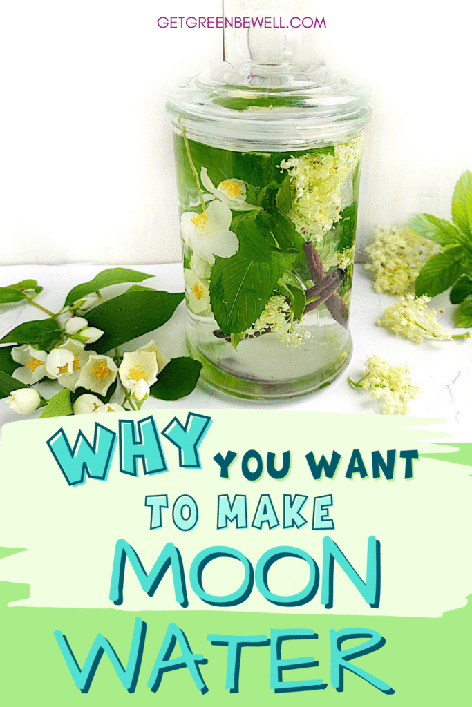 A glass of moon water with flowers and leaves.